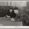 Farmers playing cards in pool room in town on a winter morning in Woodstock, Vermont
