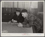 Farmers playing cards in pool room in town on a winter morning in Woodstock, Vermont