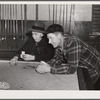 Farmers playing cards in pool room in town on a winter morning in Woodstock, Vermont