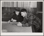 Farmers playing cards in pool room in town on a winter morning in Woodstock, Vermont