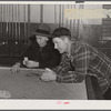 Farmers playing cards in pool room in town on a winter morning in Woodstock, Vermont