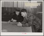 Farmers playing cards in pool room in town on a winter morning in Woodstock, Vermont