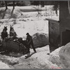 Unloading stove wood from sled woodshed. Woodstock, Vermont