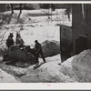 Unloading stove wood from sled woodshed. Woodstock, Vermont