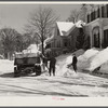 Clearing the banks of snow along main street in center of town. Woodstock, Vermont