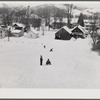Children sleigh riding down hill in center of town. Woodstock, Vermont