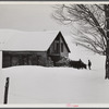 Taking wood from snowed-under woodpile into shed with team of oxen and sled. Near Barnard, Windsor County, Vermont