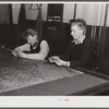 Farmer's son and friend playing cards in pool room on winter morning. Woodstock, Vermont