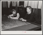 Farmer's son and friend playing cards in pool room on winter morning. Woodstock, Vermont