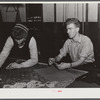 Farmer and townspeople playing cards in pool room on winter morning. Woodstock, Vermont