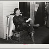 Railroad worker waiting in baggage room for train arrival. Railway station, Mount Whittier, New Hampshire