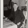 Farmer near Lisbon, New Hampshire, sorting beans for spring planting on rainy day