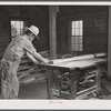 Sawing board in woodworking shop. Community service center, Centerville, Arkansas. Faulkner County (see general caption)