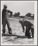 Farmers working outside woodworking shop. Community service center. Faulkner County, Centerville, Arkansas (see general caption)