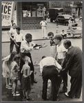 Street scene, group of men engaging in conversation with onlookers