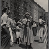 Crowded street scene with woman playing tambourine 