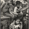 Group of young kids seated outside embracing