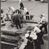 Street scene of men standing around a construction site