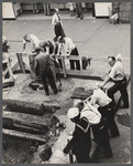 Street scene of men standing around a construction site