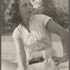 Side profile portrait of a woman seated outdoors