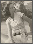 Side profile portrait of a woman seated outdoors