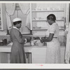 Violet Davenport and Almary Kelly canning squash during a canning demonstration given by Home Economist Rachel D. Moore at La Delta project, Thomastown, La