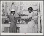 Violet Davenport and Almary Kelly canning squash during a canning demonstration given by Home Economist Rachel D. Moore at La Delta project, Thomastown, La