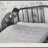 Sidney McLain adjusting the new mattress she made on the bed in her home at La Delta Project. Thomastown, Louisiana