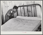 Sidney McLain adjusting the new mattress she made on the bed in her home at La Delta Project. Thomastown, Louisiana