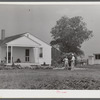 Project manager, Mr. B.A. Brady, talking to Mrs. J.G. Stanley, one of project families, in front of her home. Transylvania Project, Louisiana