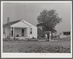 Project manager, Mr. B.A. Brady, talking to Mrs. J.G. Stanley, one of project families, in front of her home. Transylvania Project, Louisiana