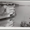 An excursion steamer which goes up the Mississippi River from New Orleans to Saint Louis every summer. It stops along the way at various towns and cities, takes passengers on a four hour "moonlite" ride, has dance orchestra, elaborate ballroom and various kinds of entertainment and amusements. Here it is tied up at Lake Providence, Louisiana before its evening trip