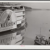 An excursion steamer which goes up the Mississippi River from New Orleans to Saint Louis every summer. It stops along the way at various towns and cities, takes passengers on a four hour "moonlite" ride, has dance orchestra, elaborate ballroom and various kinds of entertainment and amusements. Here it is tied up at Lake Providence, Louisiana before its evening trip