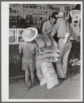 One of project family buying groceries and supplies in their co-op store. Transylvania Project, Louisiana