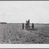 One of the project tractors plowing and discing new land. Transylvania Project, Louisiana