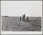 One of the project tractors plowing and discing new land. Transylvania Project, Louisiana