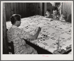 Mrs. Clarence N. Pace with her children and her mother-in-law quilting in their home. Transylvania Project, Louisiana