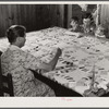 Mrs. Clarence N. Pace with her children and her mother-in-law quilting in their home. Transylvania Project, Louisiana