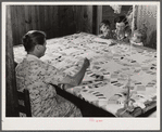 Mrs. Clarence N. Pace with her children and her mother-in-law quilting in their home. Transylvania Project, Louisiana