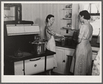 Mrs. Clarence N. Pace canning English peas in her pressure cooker with Miss Louise Martin, the home management supervisor, helping. Transylvania Project, Louisiana