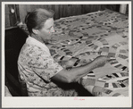 Mrs. Clarence N. Pace's mother-in-law quilting in their home. Transylvania Project, Louisiana