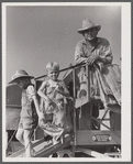 Golus Skipper on the co-op association's binder while threshing Willy Anglin's oats. Transylvania Project, Louisiana