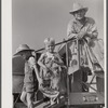Golus Skipper on the co-op association's binder while threshing Willy Anglin's oats. Transylvania Project, Louisiana
