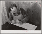 Mr. Verden Lee working on the farm family record book in his home. Transylvania Project, Louisiana