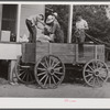 One of the project families loading up their wagon with supplies at the cooperative store. Transylvania Project, Louisiana