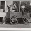 One of the project families loading up their wagon with supplies at the cooperative store. Transylvania Project, Louisiana