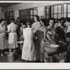 Camp members canning tomatoes in the utility building at Osceola migratory labor camp. Belle Glade, Florida