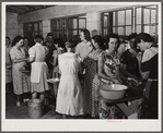 Camp members canning tomatoes in the utility building at Osceola migratory labor camp. Belle Glade, Florida