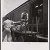 Loading mail into mail car. L&N railroad station, North Florida