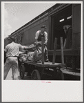 Loading mail into mail car. L&N railroad station, North Florida